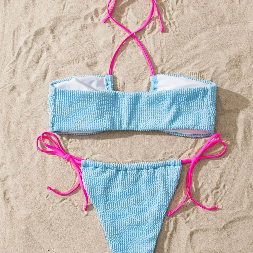 Solid colour women's two-piece swimsuit with halter neck lace-up and backless design.