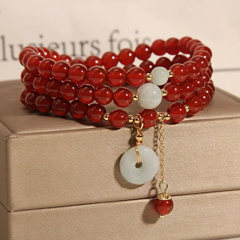 Red agate multi-layer bracelet with adjustable closure showing natural stone texture