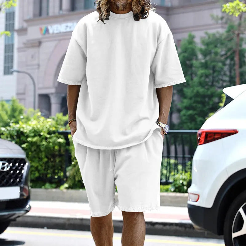 Men's casual sports suit set with grey round neck T-shirt and drawstring shorts on model