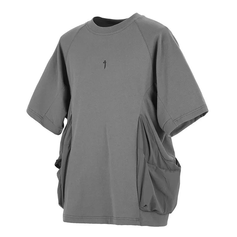 Men's loose grey cotton T-shirt with large front pockets and short sleeves.