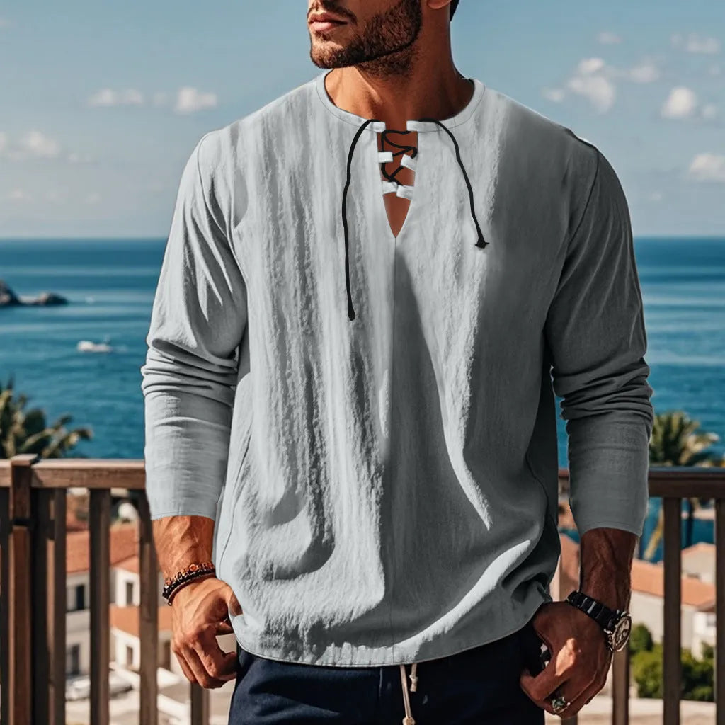 Man wearing a loose fit solid colour cotton linen beach shirt in a casual setting.