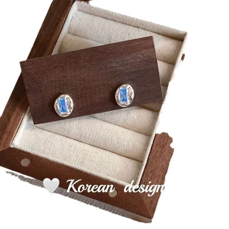 S925 sterling silver oval earrings with blue diamond heart-wrapped geometric design