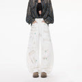 White straight leg jeans with dirty graffiti machete print for women, mid-rise non-stretch denim cotton, front view