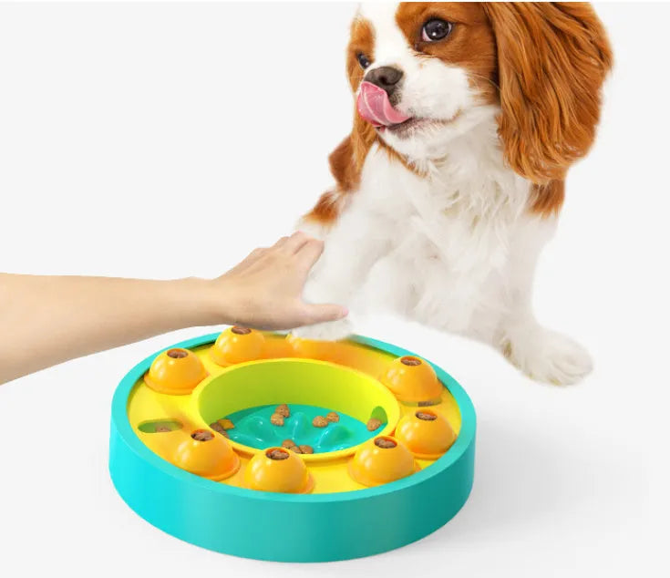 Square blue interactive dog puzzle bowl with a central feeding column and a turntable lid on a wooden floor.