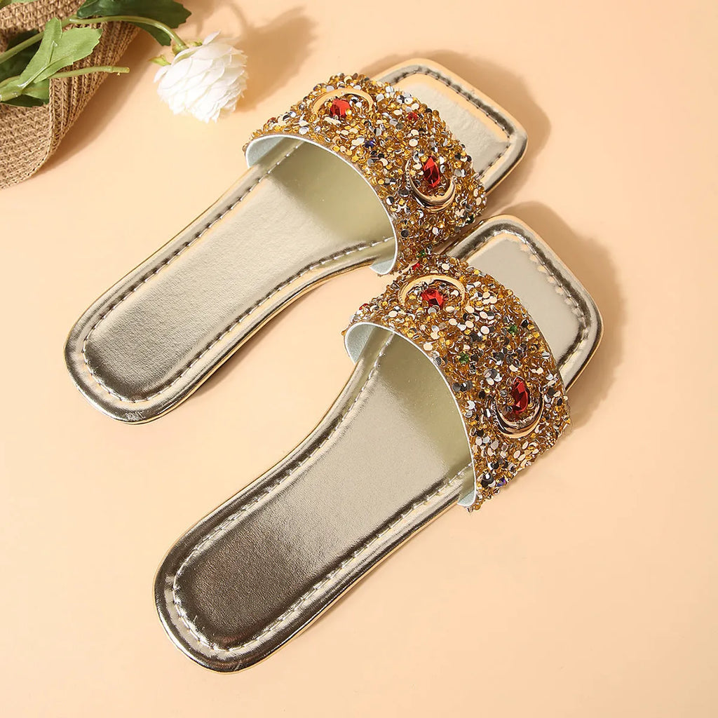 Gold women's flat slippers with rhinestone and sequin decoration on the upper.