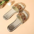 Gold women's flat slippers with rhinestone and sequin decoration on the upper.