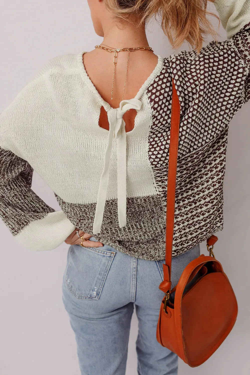 Dark khaki loose fit sweater showing back tie detail on colour block panel.