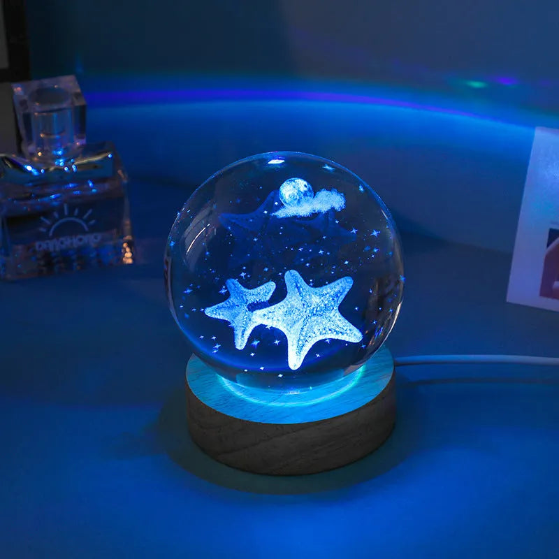 Colorful luminous crystal ball on light wooden base with data cable
