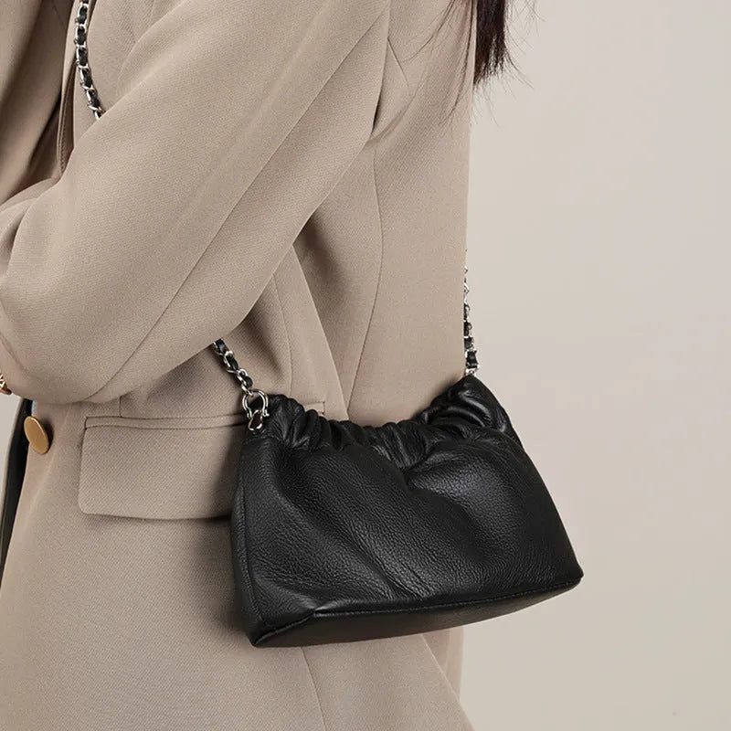 Women's soft cowhide leather crossbody bag in dumpling shape with a single strap.