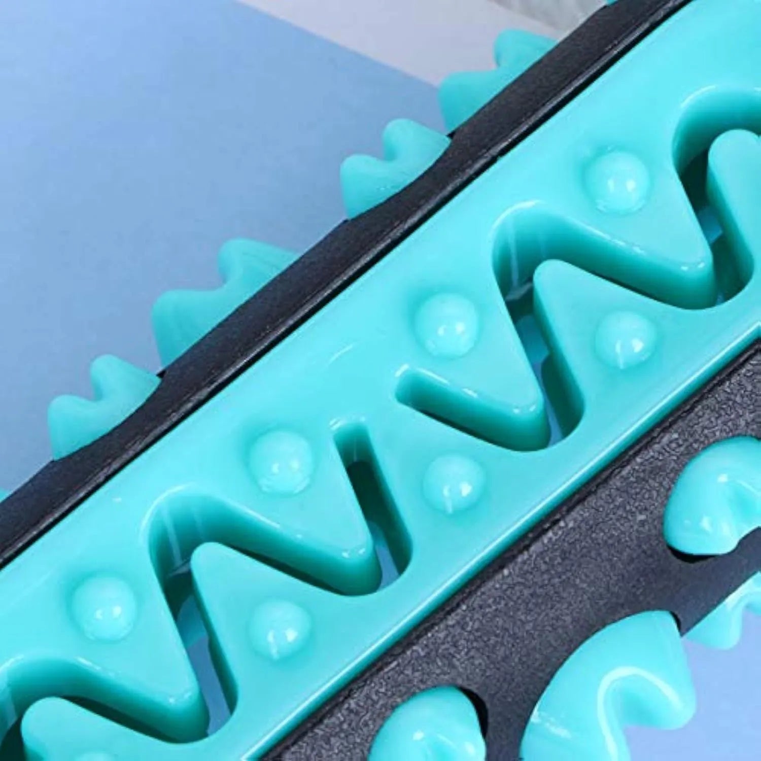 Natural rubber dog toothbrush chew toy in blue, showing textured surface for dental cleaning.