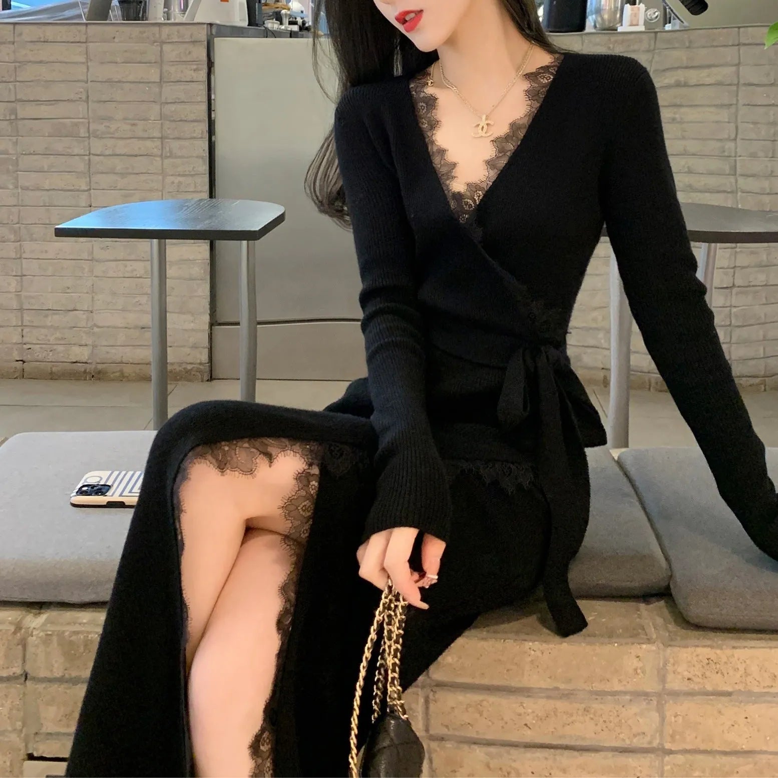 Black slim fit wool skirt dress with a princess A-line silhouette on a hanger.