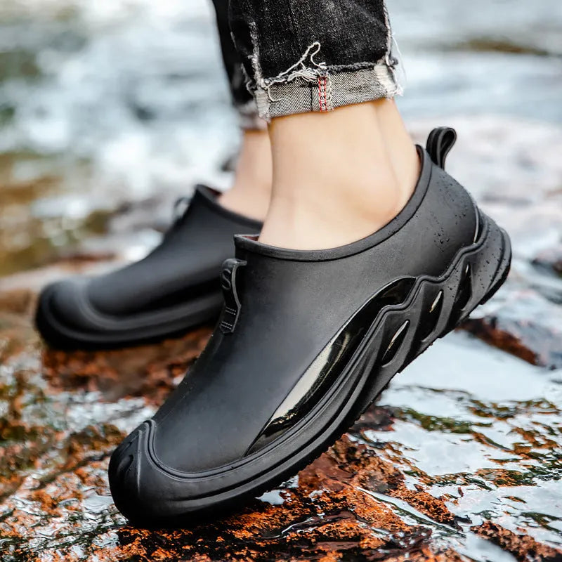 Men's solid colour short rain boots with plastic upper, shown in black, grey, and green.