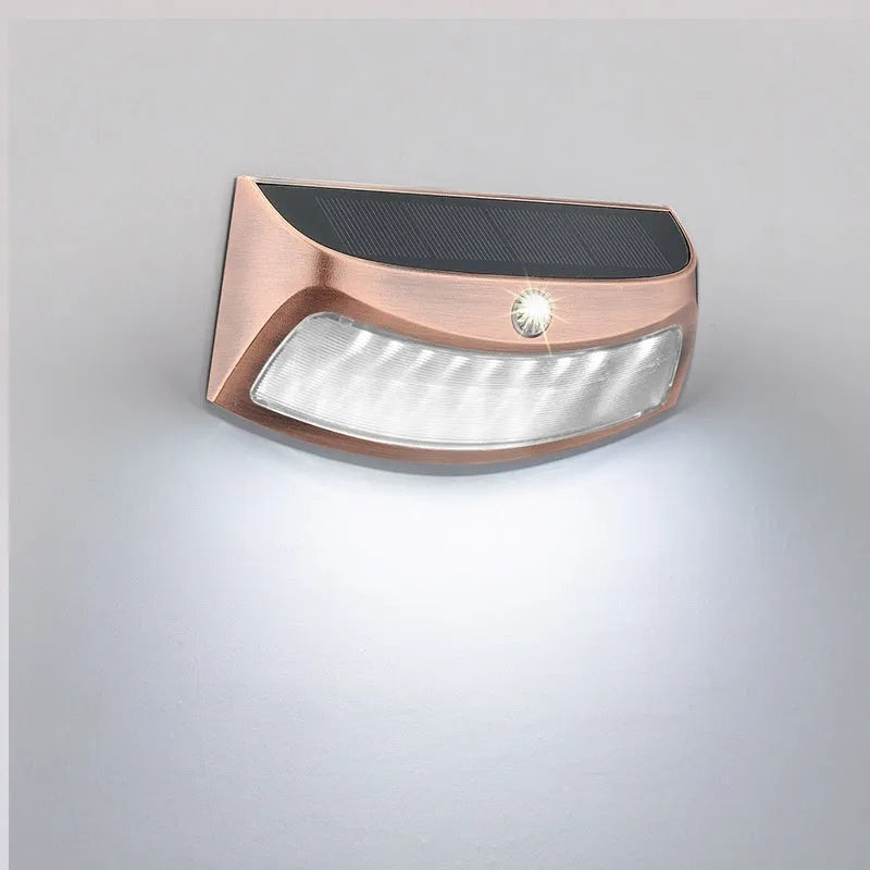 Solar-powered outdoor wall lamp with smiling face design for garden or courtyard lighting.