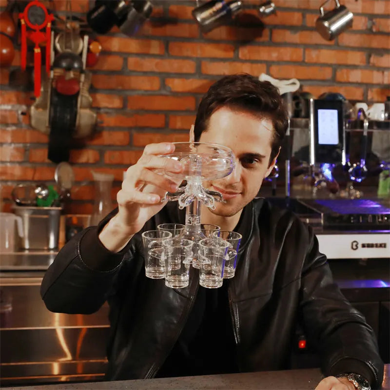 Clear PMMA 6-shot glass dispenser holder with rack and six cups on a table.