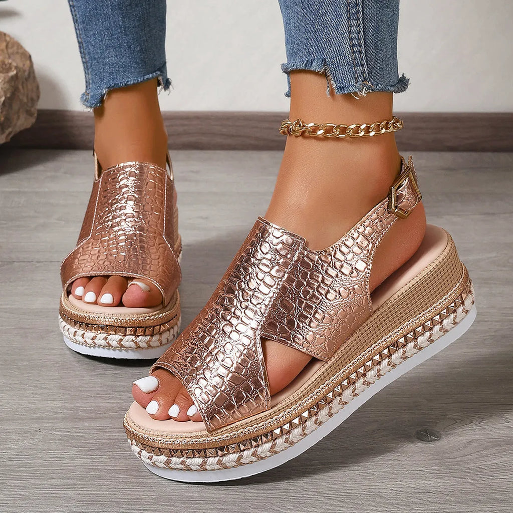 Gold Roman sandals with round toe, hollow-out design, and ankle buckle on rubber sole