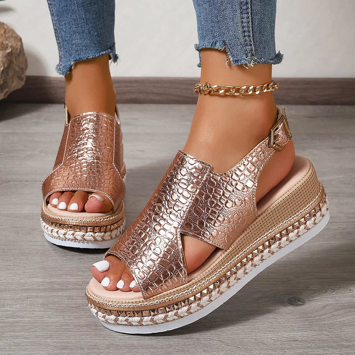Gold Roman sandals with round toe, hollow-out design, and ankle buckle on rubber sole