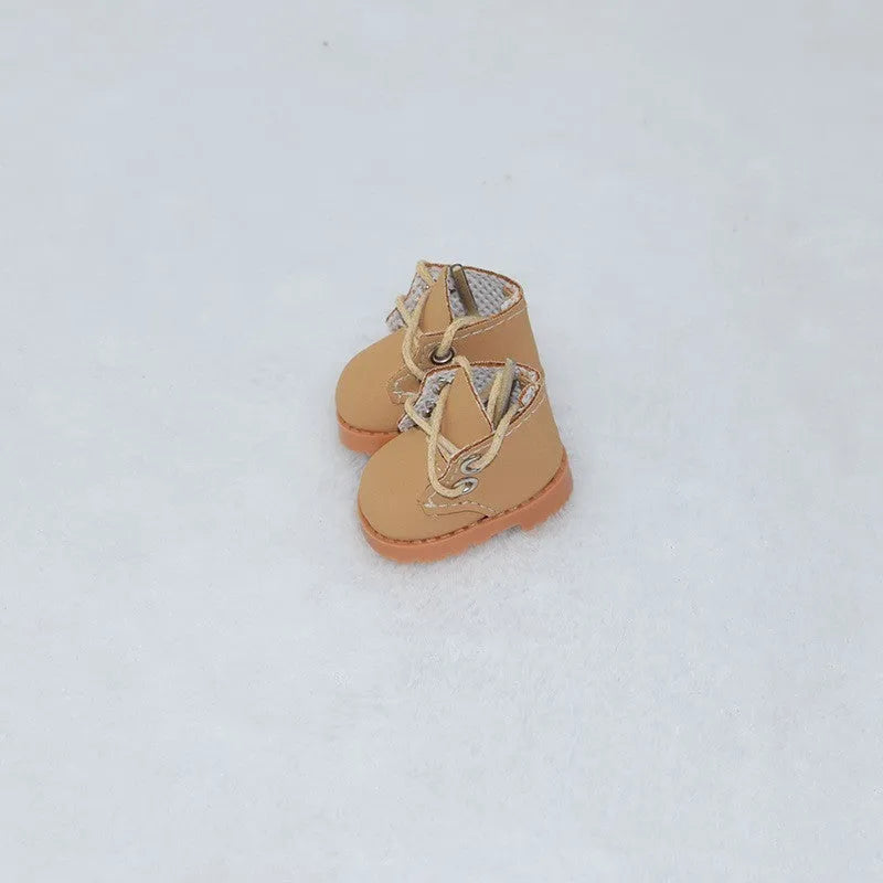 A pair of 17cm scale PU doll shoes in a selected colour and style, such as black leather shoes or brown boots.