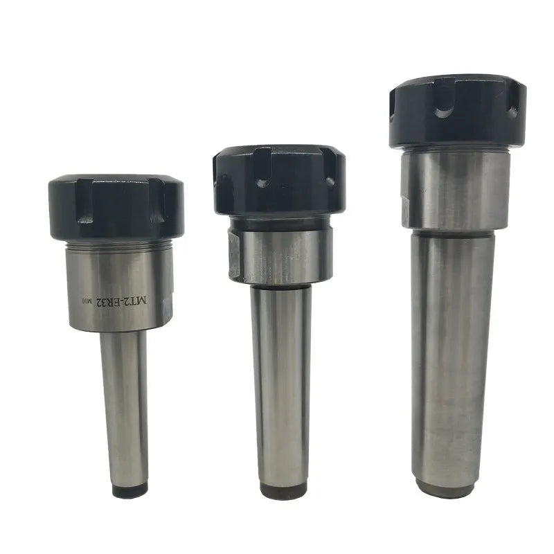 ER32 CNC milling tool set with collets, Morse taper arbor, and wrench on a workbench