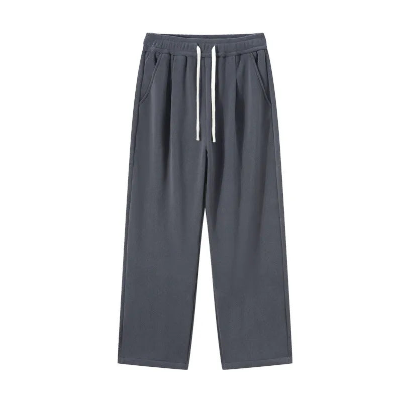 Man wearing apricot coloured loose-fit fleece-lined casual trousers with an elasticated waist.