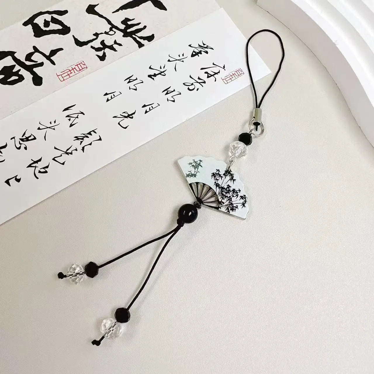Guofeng style floral beaded keychain with baked varnish finish and metal ring.