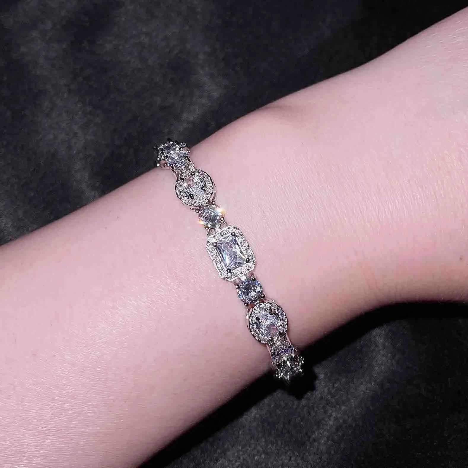 Women's geometric zircon bracelet with silver and white gold plating showing chain length options