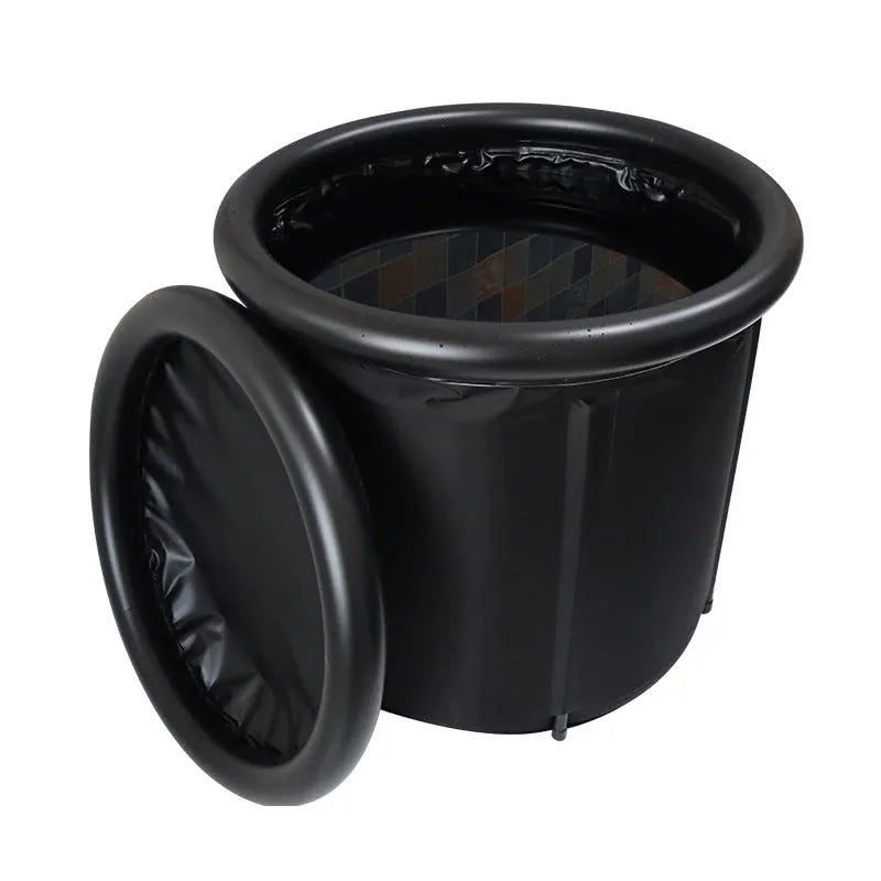 Black inflatable portable ice bath tub with weather lid, shown outdoors.