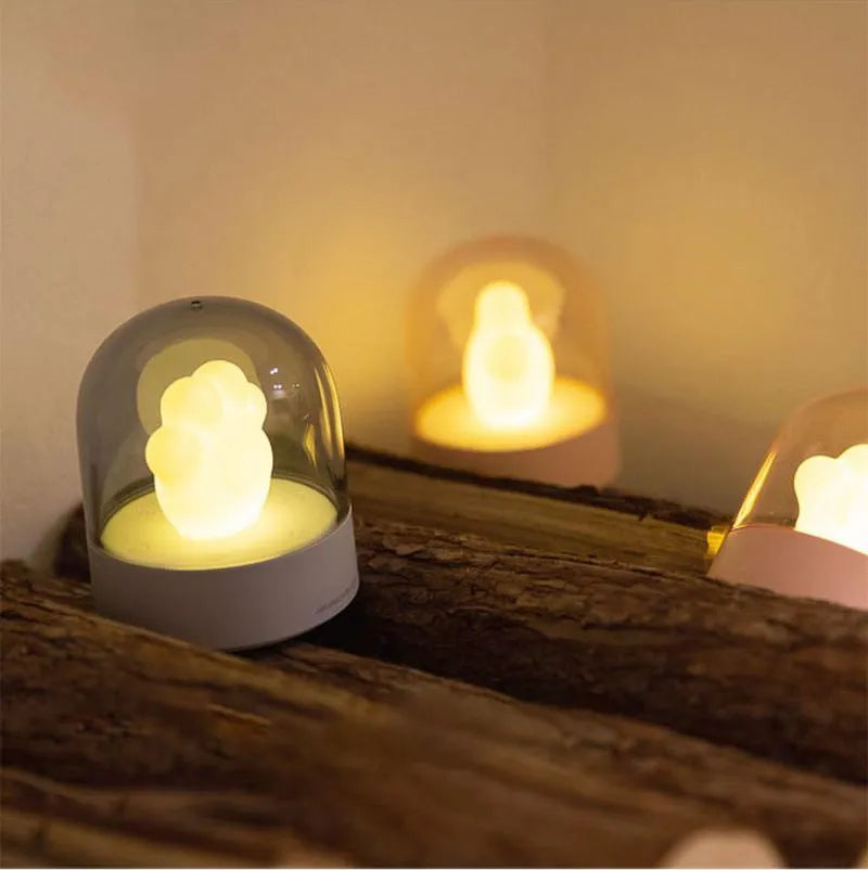 Grey cat paw shaped USB rechargeable night light with music box function on wooden desk