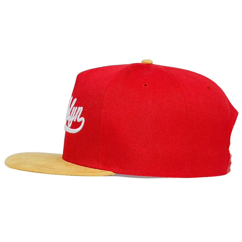 Adjustable cotton baseball cap with embroidered letters, dome top, short curved brim, in black and red for outdoor use