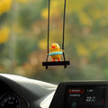 Cute little yellow duck doll car hanging ornament made from plastic with a cartoon style on a white background