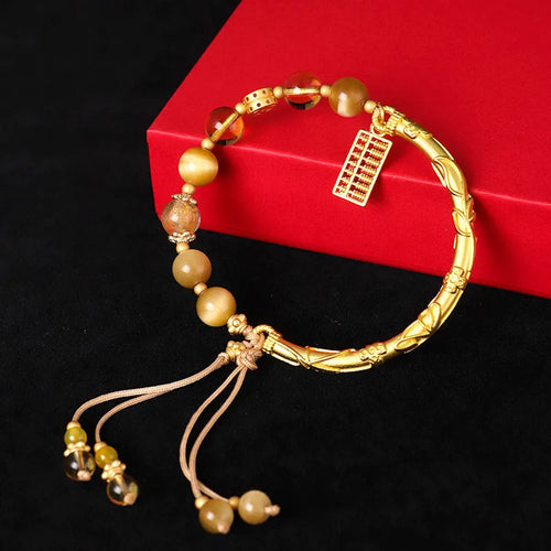 Women's beaded bracelet with tigereye, citrine, and yellow tower crystal beads in a diamond pattern.