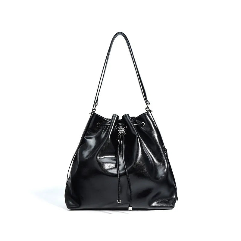 Genuine leather one shoulder bucket bag in brown showing retro style and interior pockets.
