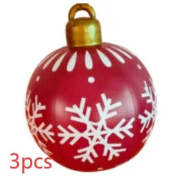Large red and white striped inflatable Christmas ball ornament hanging on an outdoor tree