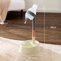 Green adjustable pet standing water dispenser with detachable pole and bowl on a grey floor.