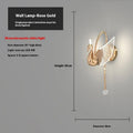 Modern gold swan-shaped wall lamp with white acrylic shade mounted on a wall.