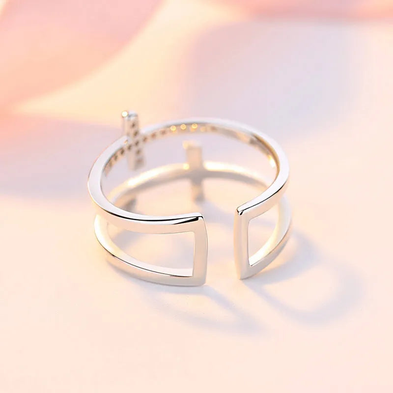 Adjustable copper ring with clear zircon stone in geometric setting, shown in gold electroplated finish