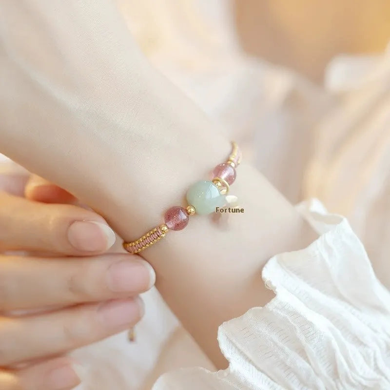 Adjustable red rope bracelet with strawberry quartz gemstones in traditional Chinese style