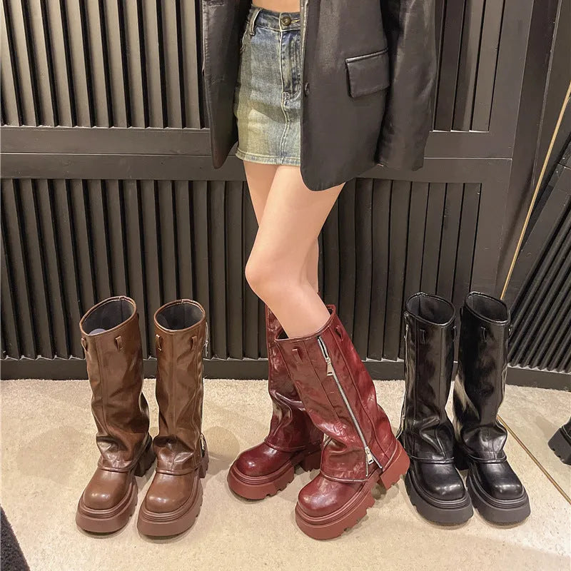 Black platform muffin pants Martin boots with a high cylinder sock and square heel.