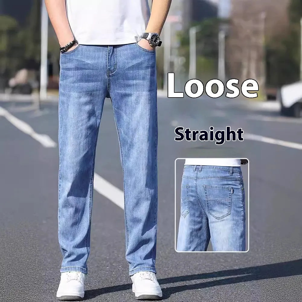 A pair of tapered fit stretch denim trousers in a light blue colour, laid flat.