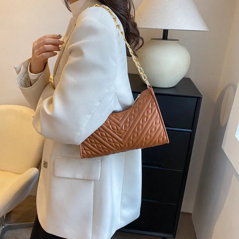 Brown PU pleated chain baguette shoulder bag showing vertical square shape and soft carry handle.