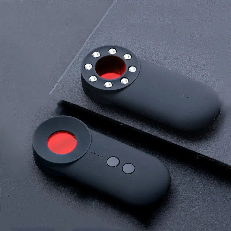 Black portable camera and GPS signal detector with USB charging port on a flat surface.