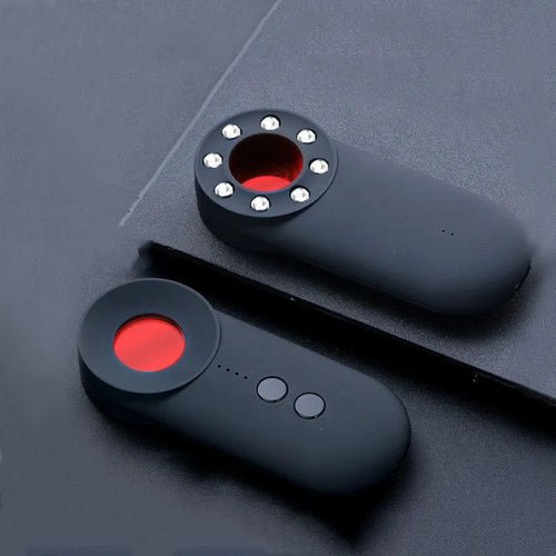 Black portable camera and GPS signal detector with USB charging port on a flat surface.