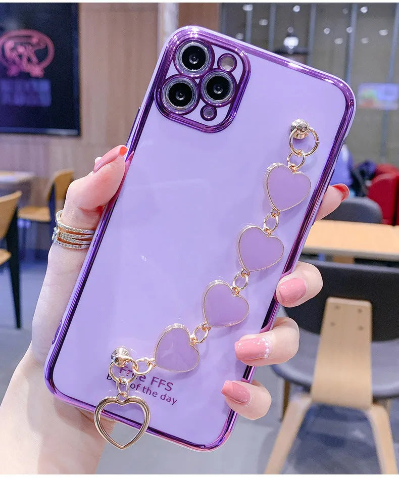Silicone phone case with wrist bracelet for Samsung smartphones in solid green, pink, purple, or light green.