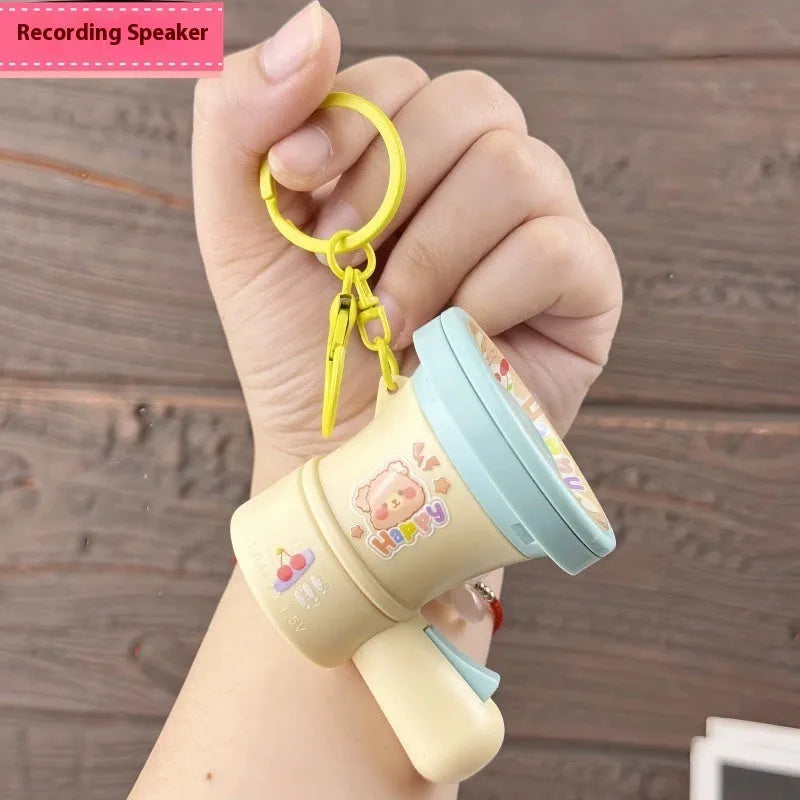 Green or yellow plastic cartoon horn keychain ornament on plastic key ring