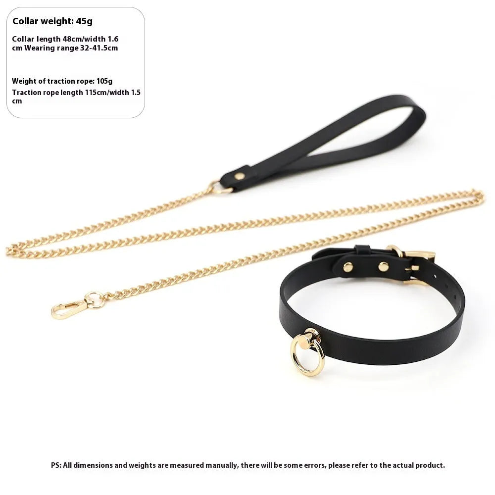 Genuine cowhide leather collar with metal fittings and a connected pull lead on a dark surface.