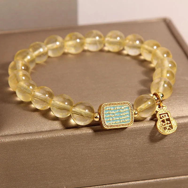 Women's yellow citrine crystal bracelet with rhinestone decorations on wrist