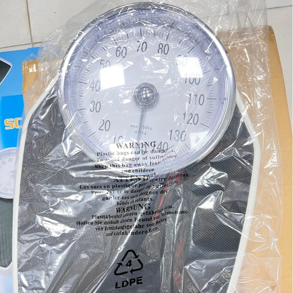 Large dial mechanical pointer body weight scale in black, 47x35x11cm, on bathroom floor