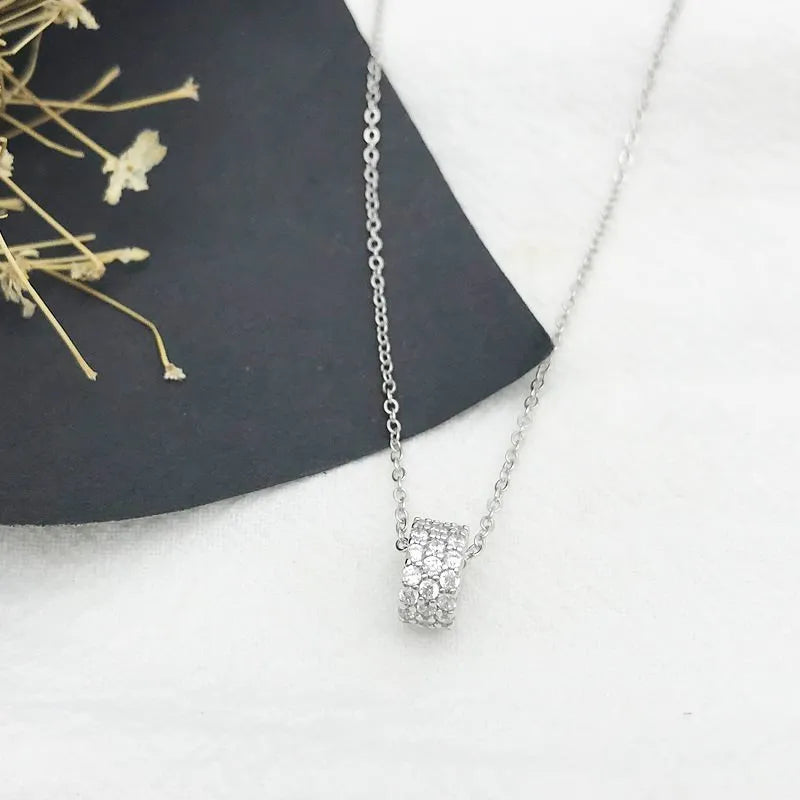 925 silver necklace with small waist pendant and platinum electroplate finish on white background