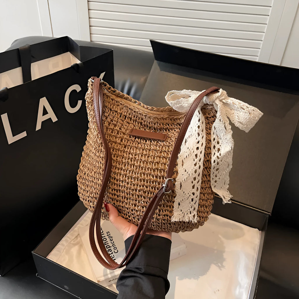 Women's woven straw messenger bag with hollowed design and single shoulder strap in khaki colour