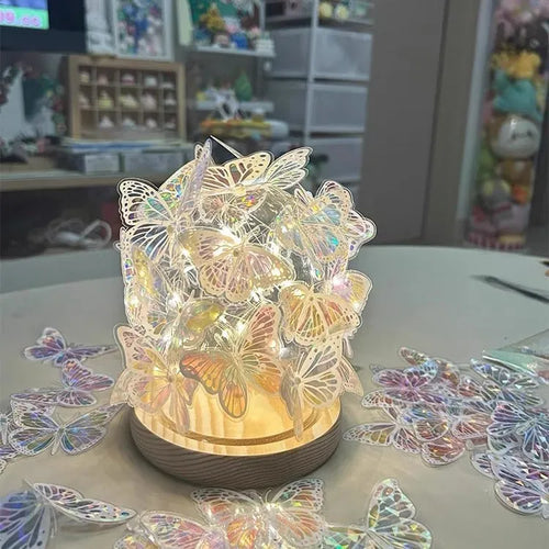 Handmade butterfly night lamp with glass shade on raw wood base measuring 12x15cm
