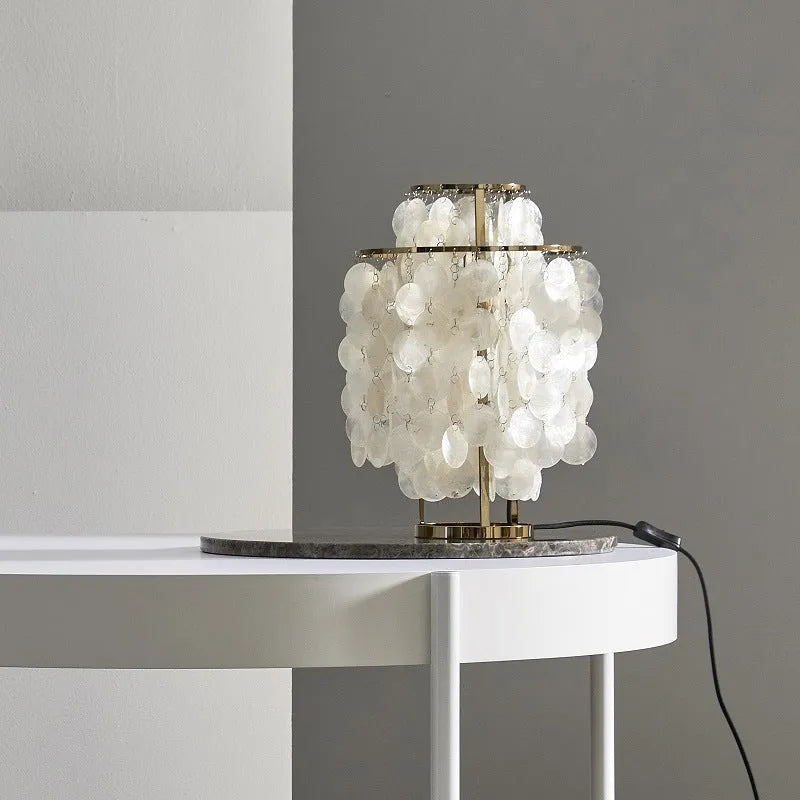 Shell-shaped bedside table lamp in chrome finish measuring 30cm diameter by 46cm tall